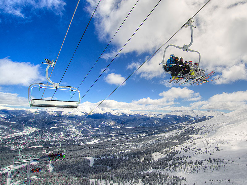 People riding a chairlift at Breckenridge
