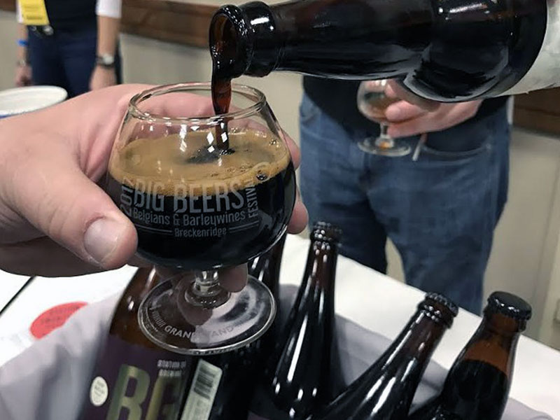 Dark beer being poured into glass